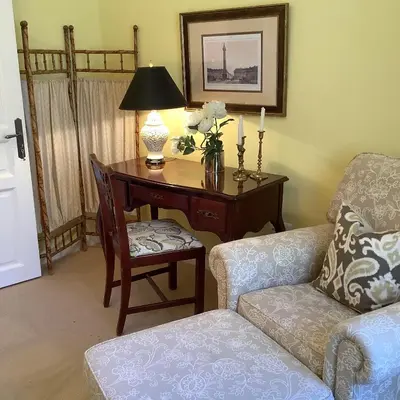 a living room with a desk with a lamp and a chair at Mille Fleurs in Castres