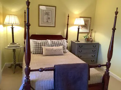 a bedroom with a bed and two lamps and a dresser at Mille Fleurs in Castres