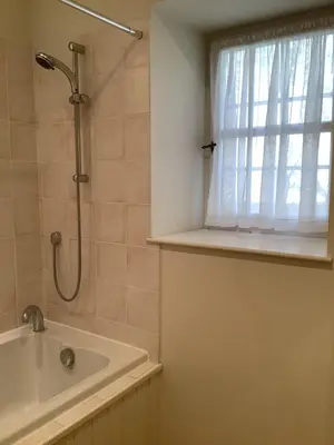 a bathroom with a shower and a sink and a window at Mille Fleurs in Castres