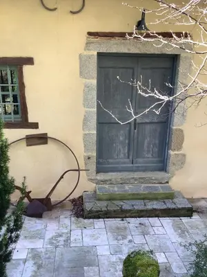 a building with a large door and a window at Mille Fleurs in Castres