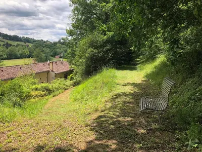 a bench sitting on the side of a hill at Mille Fleurs in Castres