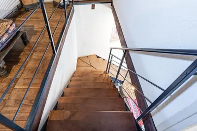 a stairway leading to the second floor of a house at La Rustique, maison de charme proche Carcassonne - jardin, wifi, tout équipée in Cuxac-Cabardès