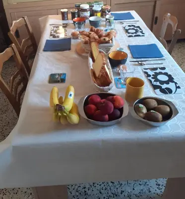 a table with fruits and vegetables in bowls on it at Serge Le Belge - Sejour authentique chez l habitant a Lezignan Corbieres in Lézignan-Corbières