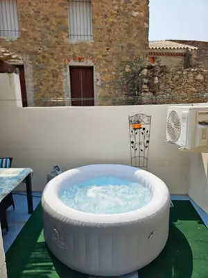 a large hot tub on the balcony of a house at Serge Le Belge - Sejour authentique chez l habitant a Lezignan Corbieres in Lézignan-Corbières