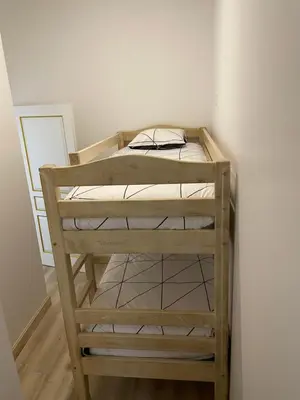 a wooden bunk bed in a corner of a room at Studio familial Maison de L'église du Couvent in Narbonne