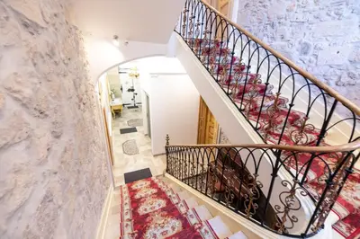 a staircase in a home with a marble wall at Studio familial Maison de L'église du Couvent in Narbonne