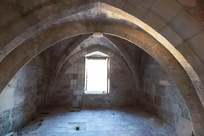 an empty room with a window in a building at Studio familial Maison de L'église du Couvent in Narbonne