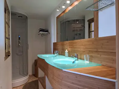 a bathroom with a blue sink and a shower at La Caminada Vielha in Montaillou