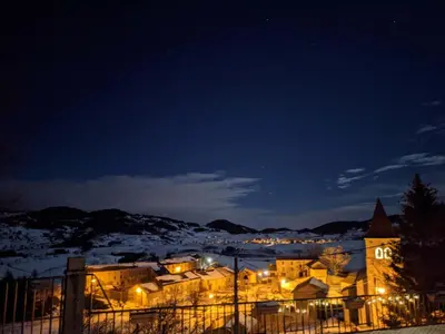 a town in the snow at night at La Caminada Vielha in Montaillou