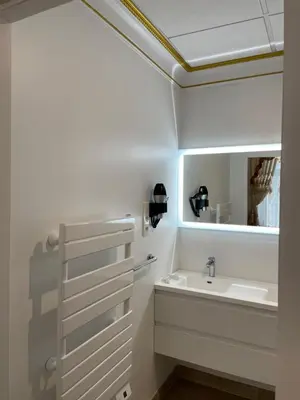 a bathroom with a sink and a mirror at Chambre a Baldaquin Maison de L'Église Du couvent in Narbonne