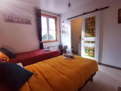 a hotel room with two beds and a window at Libre à vous ... in Félines-Termenès