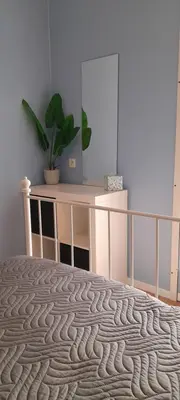 a bedroom with a bed and a desk with a plant at Sur la Bonnefooi in Prades-sur-Vernazobre