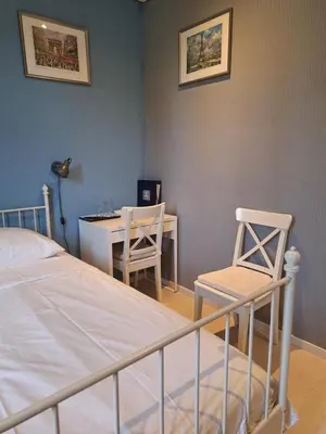 a bedroom with a bed and a table and chairs at Sur la Bonnefooi in Prades-sur-Vernazobre