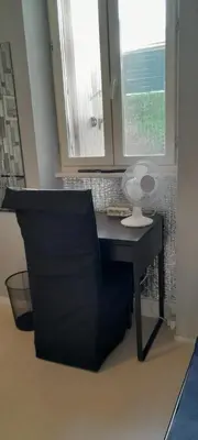 a desk with a lamp on it in a room with a window at Sur la Bonnefooi in Prades-sur-Vernazobre