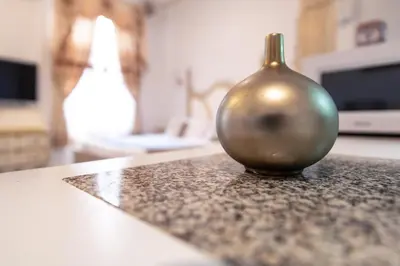 a silver vase sitting on top of a counter at Studio du Maire Maison de L'Église du Couvent in Narbonne