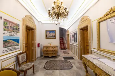 a hallway with a chandelier and a table and chairs at Studio du Maire Maison de L'Église du Couvent in Narbonne