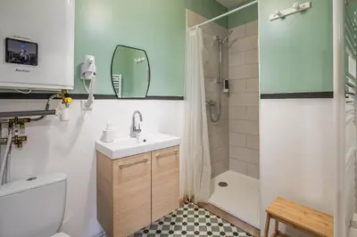 a bathroom with a sink and a toilet and a shower at Cosy Green Clim Wifi Centre ville 2 pers in Lézignan-Corbières