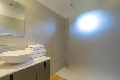 a bathroom with a white sink and a mirror at Les Pimprenelles in Carcassonne