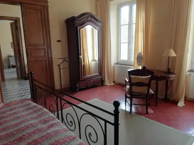 a bedroom with a bed and a desk and a table at Maison La vie est belle in Luc-sur-Orbieu