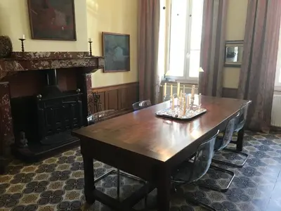 a dining room with a wooden table with candles on it at Maison La vie est belle in Luc-sur-Orbieu