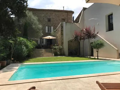 a swimming pool in front of a house at Maison La vie est belle in Luc-sur-Orbieu