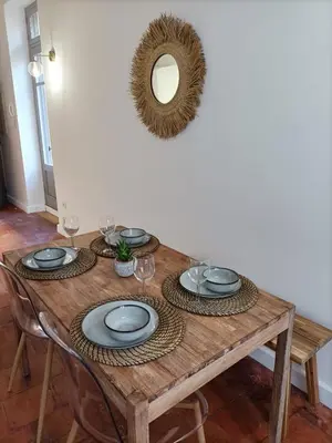 a wooden table with plates and glasses and a mirror at La Dolce Vita in Carcassonne