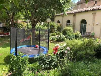 a bird cage with a ball in it in a yard at La Vie en Roses in Rennes-les-Bains