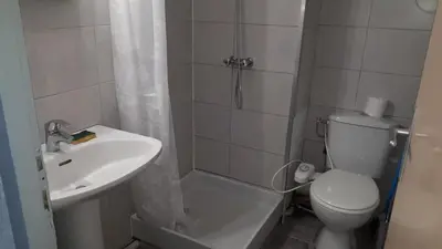 a bathroom with a sink and a toilet and a shower at Studio cabine avec jardinet à 30 m de la plage, au calme. in Gruissan