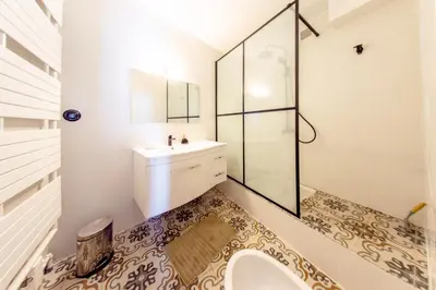 a bathroom with a sink and a glass shower at RétroMirabeau 
