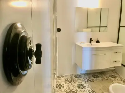 a bathroom with a shower with a toilet and a sink at RétroMirabeau 