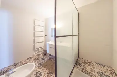 a bathroom with a toilet and a sink at RétroMirabeau 