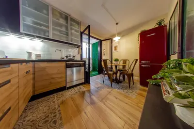 a kitchen with a red refrigerator and a table at RétroMirabeau 