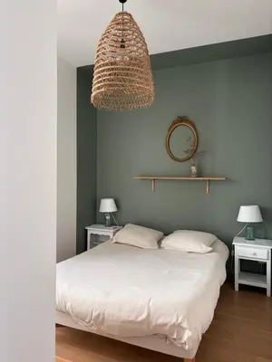 a bedroom with a bed with two pillows at La maison cocooning in Narbonne