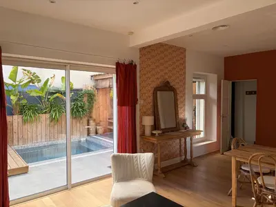 a living room with a couch and a table at La maison cocooning in Narbonne