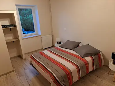 a bedroom with a bed with two pillows and a window at Gîte La Dolce Vita in Saint-Félix-Lauragais