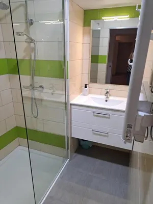 a bathroom with a shower and a sink and a mirror at Gîte La Dolce Vita in Saint-Félix-Lauragais