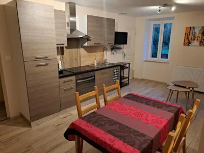 a kitchen with a table and a dining room at Gîte La Dolce Vita in Saint-Félix-Lauragais