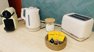 a counter top with a toaster and a toaster at Le Bout du Monde Appartement Hyper-centre in Carcassonne