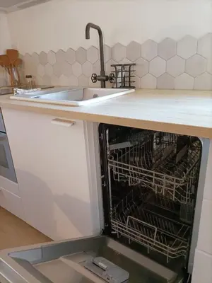 a dishwasher under a kitchen counter with a sink at L’UNDERGROUND Studio Hyper-Centre in Carcassonne