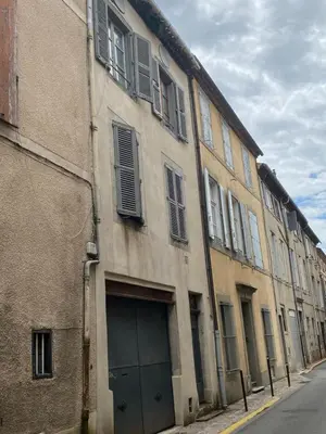 a building with a garage door on the side of a street at Le studio Hyper-centre in Carcassonne