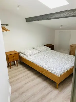 a bedroom with a bed and two night stands at Le studio Hyper-centre in Carcassonne