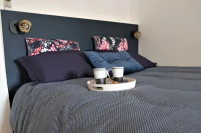 a bed with a tray with two cups on it at A l'ombre des remparts in Carcassonne