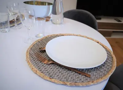 a table with a plate and fork and glasses at A l'ombre des remparts in Carcassonne