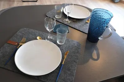 a black table with white plates and glasses on it at A l'ombre des remparts in Carcassonne