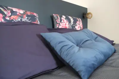 a blue pillow sitting on top of a bed at A l'ombre des remparts in Carcassonne