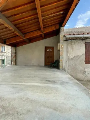 a large patio with a wooden ceiling at GIte place République in Pézilla-de-Conflent