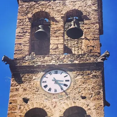 a clock tower with two bells on top of it at GIte place République in Pézilla-de-Conflent