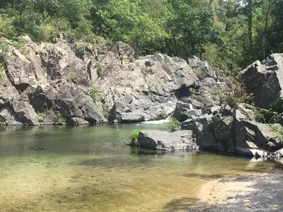 a river with some rocks in the water at GIte place République in Pézilla-de-Conflent