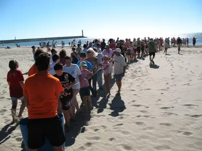 a large group of people walking on the beach at APPARTEMENT 6 PERSONNES in Port-la-Nouvelle