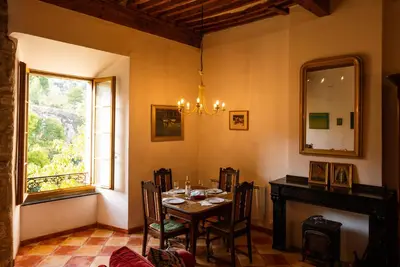 a dining room with a table and a window at The Riverside Gîte Lagrasse in Lagrasse